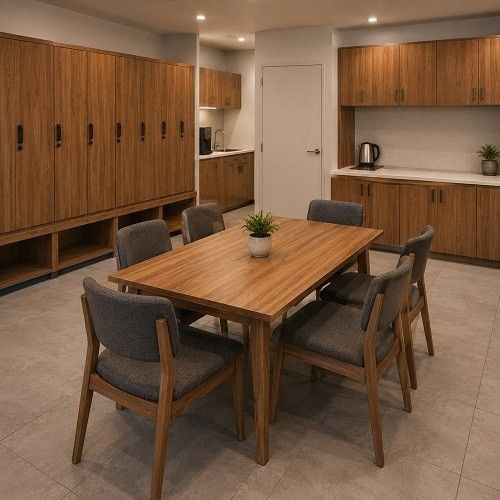 Hotel staff area with wooden lockers, dining table, chairs, cabinets and pantry storage
